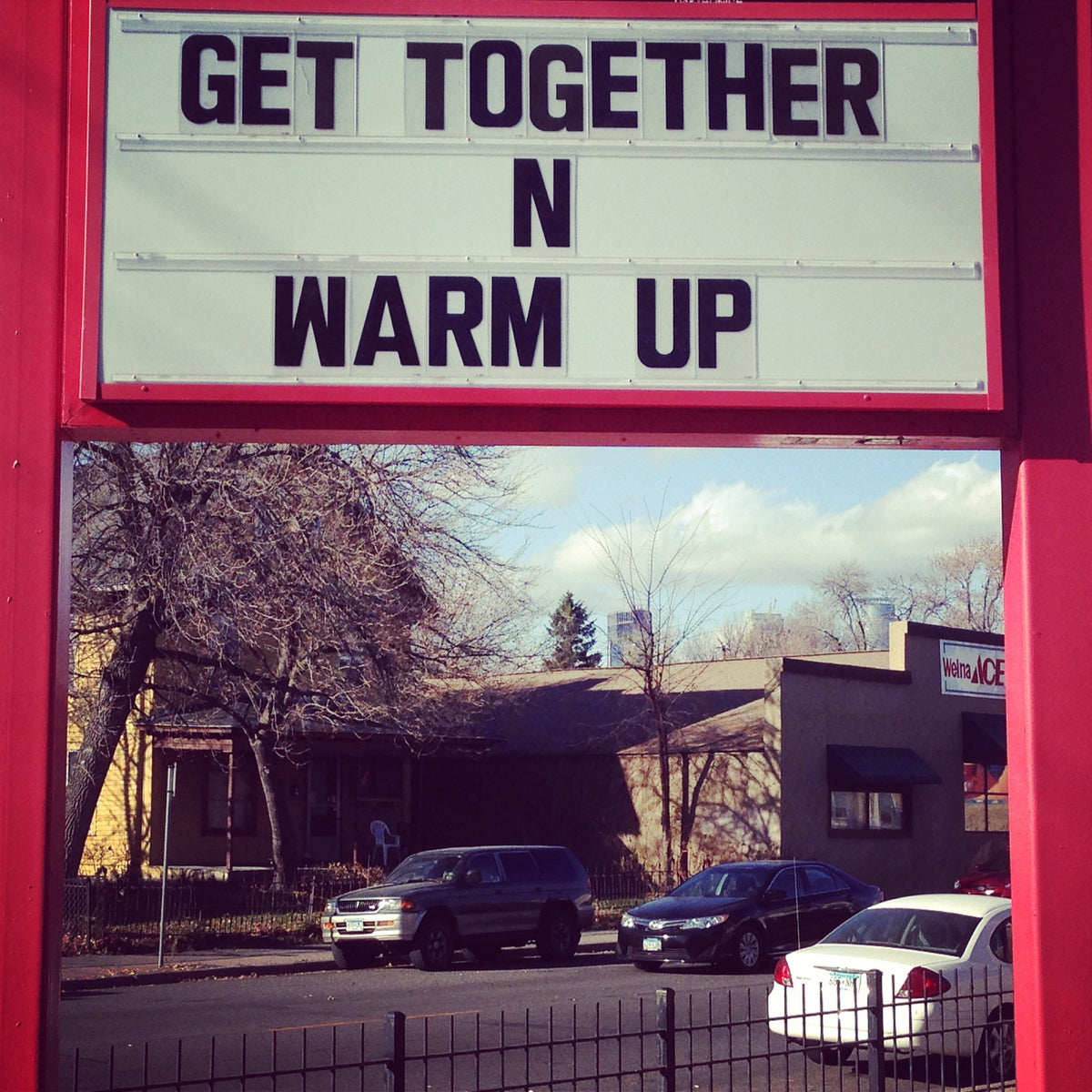 Red neighborhood sign reading Get Together N Warm Up